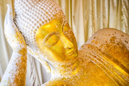 White Buddha covered with gold foil on の写真素材