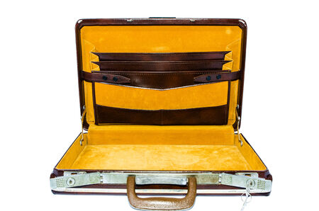 Old brown suitcase inside with velvet gold on a white background 