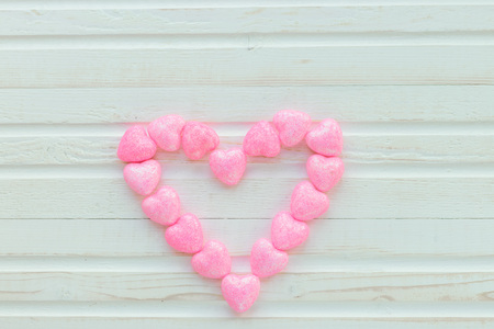 Pink heart on a white background wooden