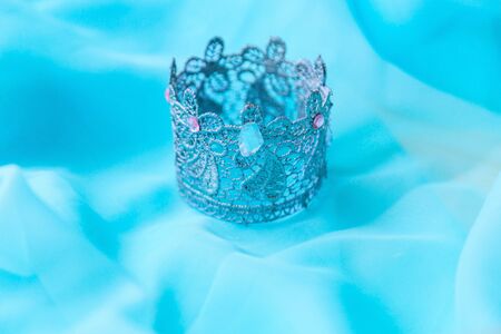 Silver crown on a blue background