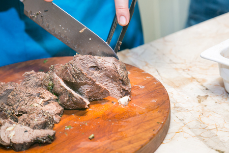 Cook cuts roasted beef meatの写真素材