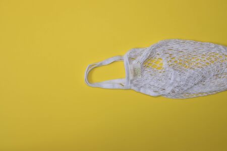 Reusable shopping bags white on yellow background. Zero waste concept. No plastic.
