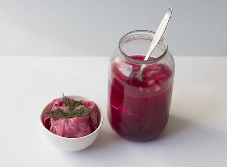 fermented cabbage, with beets on a plate, in a glass jar