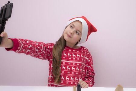 little girl blogger, influence, in a Christmas hatの写真素材