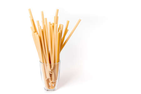 beautiful fresh and raw wholegrain bucatini ,thick, corkscrew shaped pasta on wood board. shallow DOFの写真素材