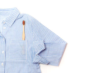 pajamas shirt and wooden toothbrush on a white backgroundの写真素材