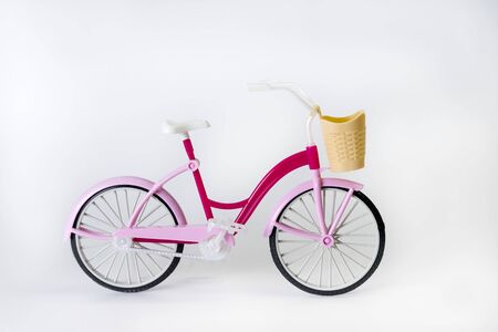 pink bicycle with basket on a white background, doll toy, small bike, subject filming, isolate, cycling, Sport Activity Healthy lifestyle の写真素材
