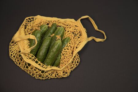 Fresh green cucumbers vegetables in reusable shopping eco-frendly mesh baの写真素材