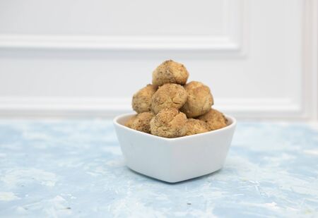 Tasty sugar cookies balls on wooden table.