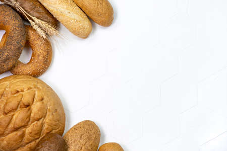 Different kinds of fresh bread on light background