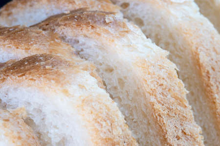 Closeup macro of loaf of bread with slices