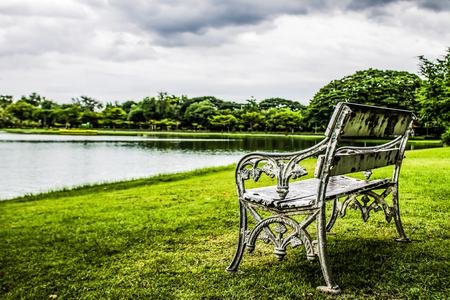 The old white bench on the water.
 In the natural gardenの写真素材