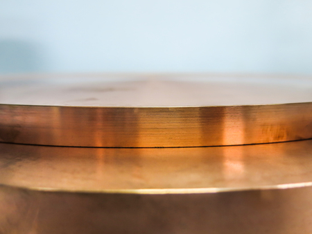 Two copper plates laid over each other with light to work.の写真素材