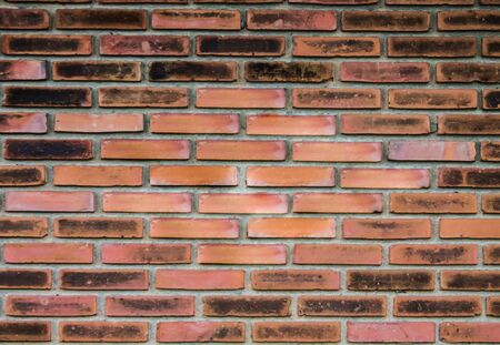 The old orange brick walls are stained with dirt, but watch the wall.