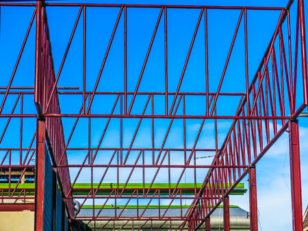 construction project frame roof steel red blue sky
