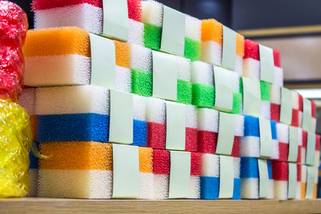 Sponge, a variety of color pack, put together on a wooden rack. Stocks for sale