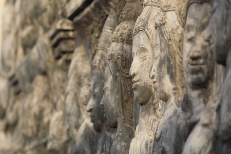 Asian carved stone faces with a serene expression の写真素材