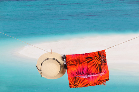 Straw hat sun glasses on a tropical beachの写真素材