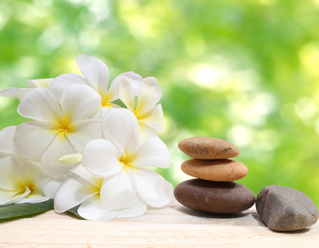 Zen spa concept background  Zen massage stones with frangipani plumeria flowerの写真素材