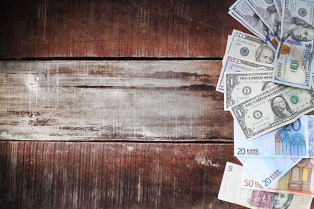 dollars banknotes and euro money on the wooden tableの写真素材