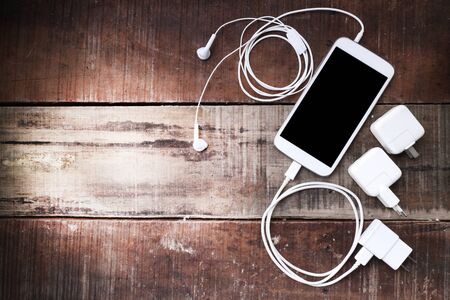 Smart phone on wooden table background with copy spaceの写真素材