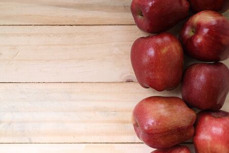 Sweet apples on wooden backgroundの写真素材