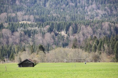 old wooden hut cabin in mountain alps at rural fall landscapeの写真素材