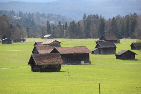 old wooden hut cabin in mountain alps at rural fall landscapeの写真素材