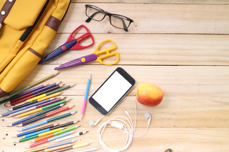 Outfit of traveler, student, teenager, young woman or guy. Overhead of essentials for modern young person. Different objects on wooden background.の写真素材