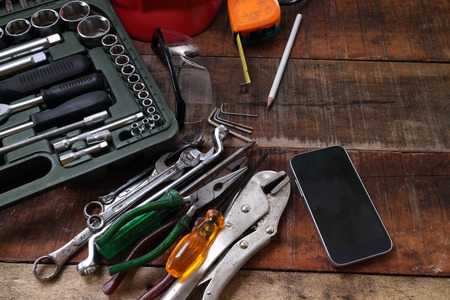 set of hand tools on a wooden tableの写真素材