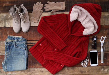 Outfit of traveler, student, teenager, young woman or guy. Overhead of essentials for modern young person. Different objects on wooden background.の写真素材