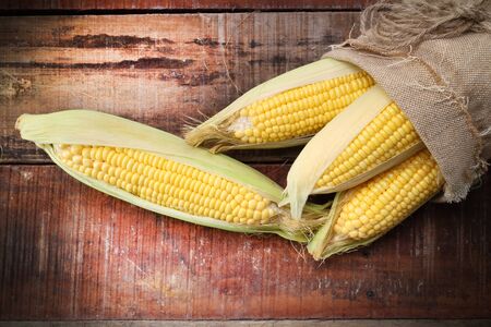 fresh corn on wooden tableの写真素材