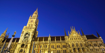 Medieval Town Hall building with spires Munich Germany. The first floor looks towards the Marienplatz- used for festivals and public events. The daily clock tower show is a tourist attraction.の写真素材