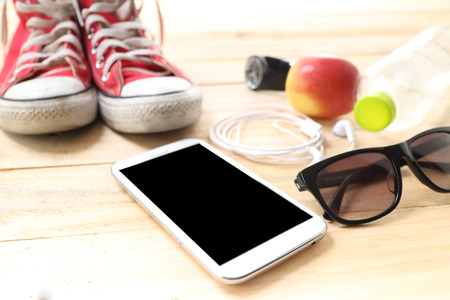 Outfit of traveler, student, teenager, young woman or guy. Overhead of essentials for modern young person. Different objects on wooden background.の写真素材