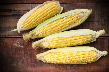 fresh corn on wooden tableの写真素材