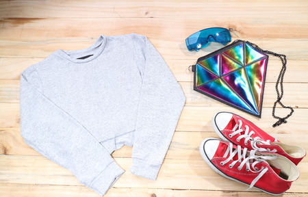 Outfit of traveler, student, teenager, young woman or guy. Overhead of essentials for modern young person. Different objects on wooden background.の写真素材
