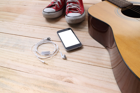 Outfit of traveler, student, teenager, young woman or guy. Overhead of essentials for modern young person. Different objects on wooden background.の写真素材