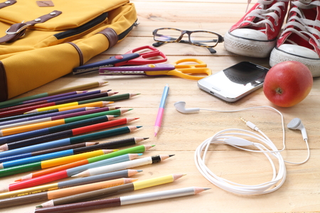 Outfit of traveler, student, teenager, young woman or guy. Overhead of essentials for modern young person. Different objects on wooden background.の写真素材