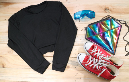 Outfit of traveler, student, teenager, young woman or guy. Overhead of essentials for modern young person. Different objects on wooden background.の写真素材