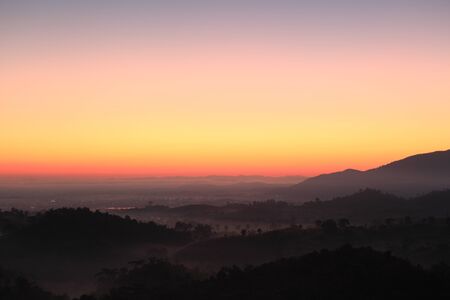 Colorful autumn landscape in the mountain village. Foggy morning and sunlight beautiful timeの写真素材