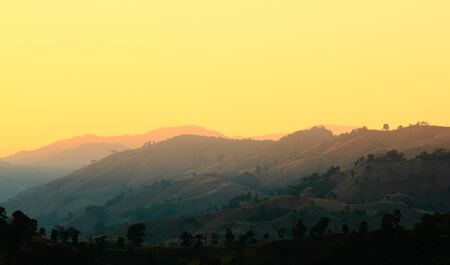 Colorful autumn landscape in the mountain village. Foggy morning and sunlight beautiful timeの写真素材