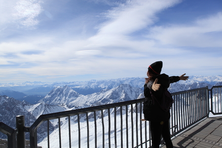 Winter snow covered mountain Zugspitze in Germany Europe. woman  standing and happy at moment time