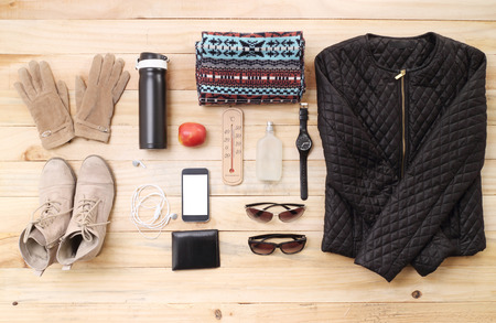 Outfit of traveler, student, teenager, young woman or guy. Overhead of essentials for modern young person. Different objects on wooden background.の写真素材