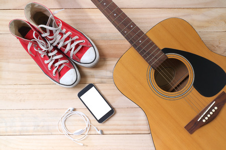 Outfit of traveler, student, teenager, young woman or guy. Overhead of essentials for modern young person. Different objects on wooden background.の写真素材