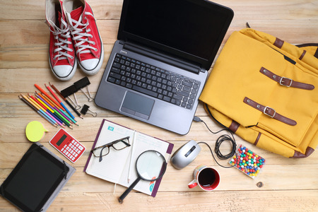 overhead of office table or student table  with notebook, computer keyboard and mouse, tablet pc and smartphone. copy spaceの写真素材