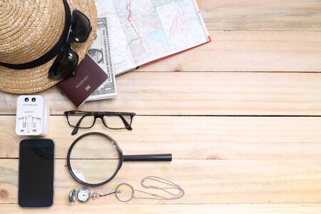 travel concept,  Preparation for travel,  money, passport, road map on wooden tableの写真素材