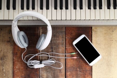 Outfit of traveler, student, teenager, young woman or guy. Overhead of essentials for modern young person. Different objects on wooden background.の写真素材