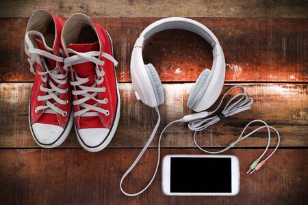 Outfit of traveler, student, teenager, young woman or guy. Overhead of essentials for modern young person. Different objects on wooden background.の写真素材