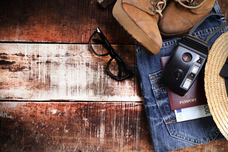 Outfit of traveler, student, teenager, young woman or guy. Overhead of essentials for modern young person. Different objects on wooden background.の写真素材