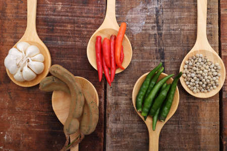 Spices and herbs in  wooden spoons.